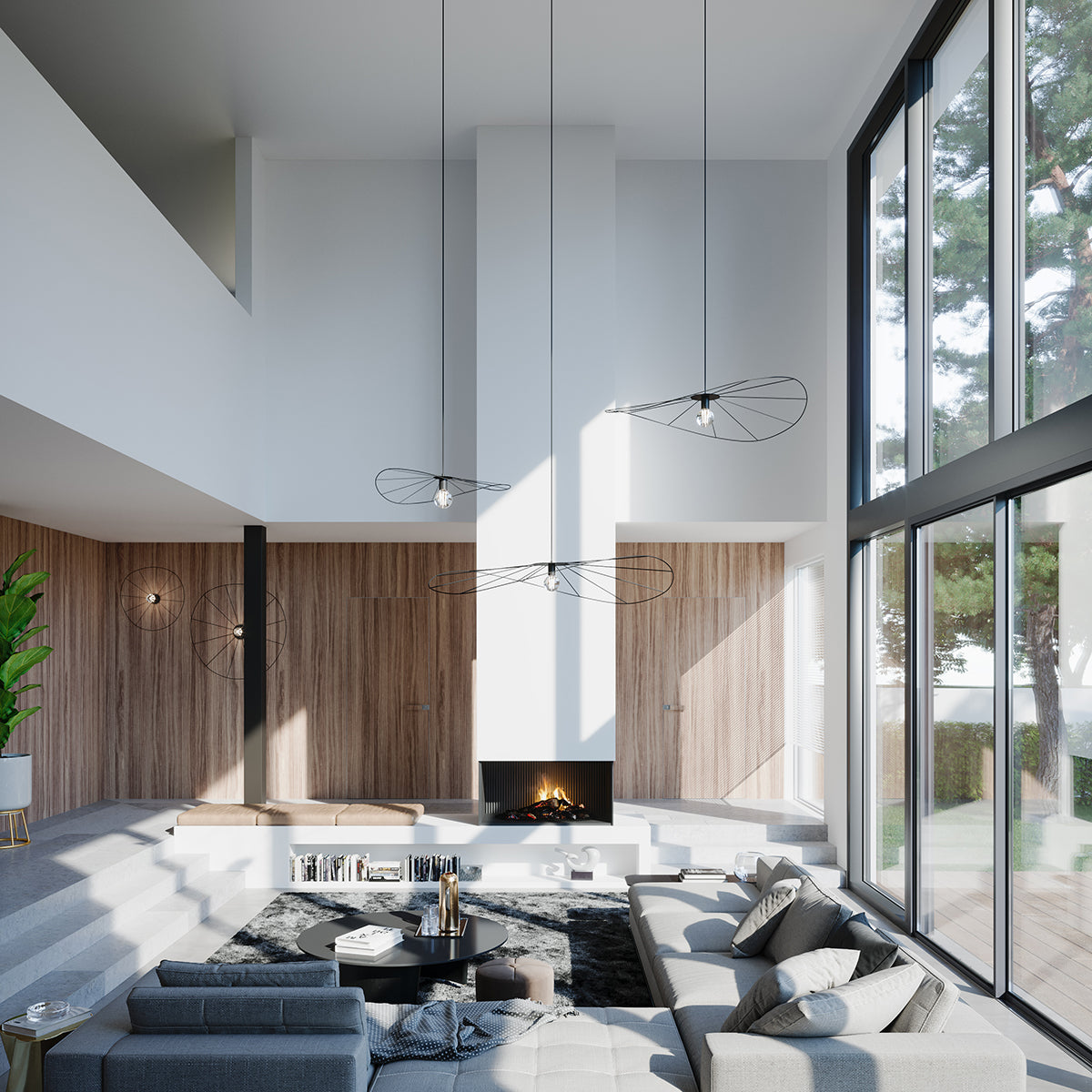 Mise en ambiance avec trois suspensions noires dans un salon en double hauteur