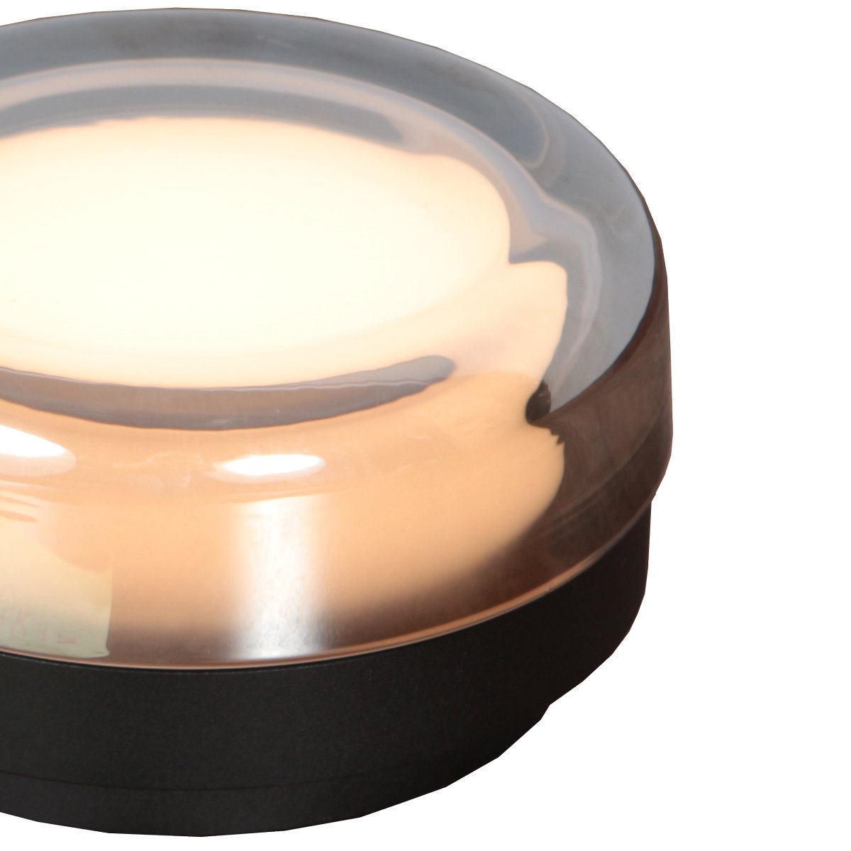 Vue de dessus du luminaire rond, verre ambré, câble d'alimentation sortant du socle.