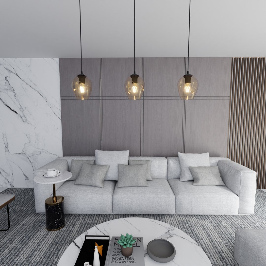 Mise en ambiance salon avec trois suspensions éclairées devant un mur gris