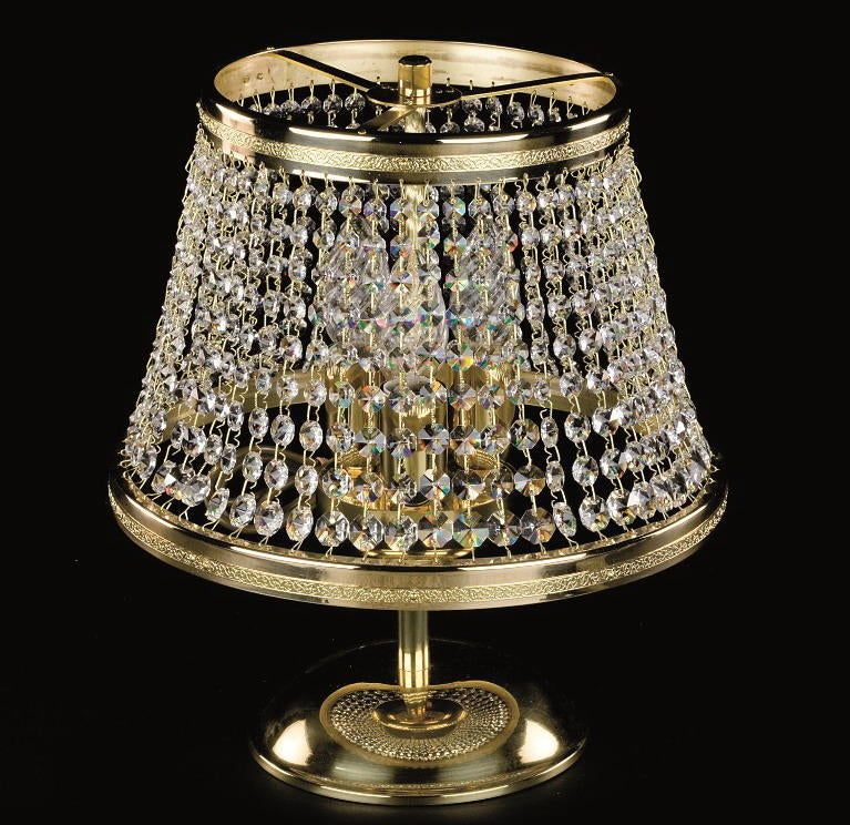 Lampe à poser dorée avec abat-jour en cristaux suspendus et base ronde.