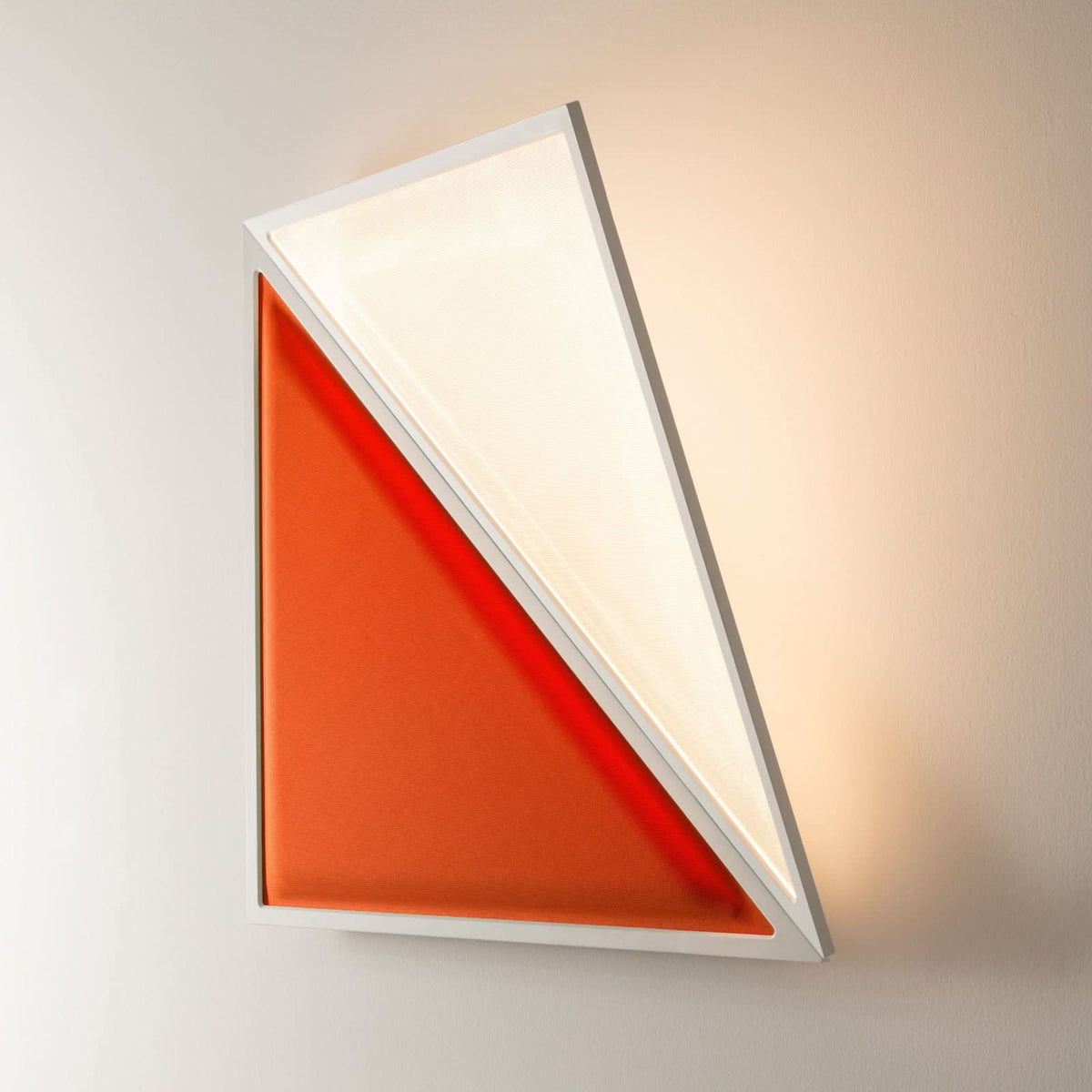 Applique murale à panneaux triangulaires orange et blanc, allumée sur un mur.