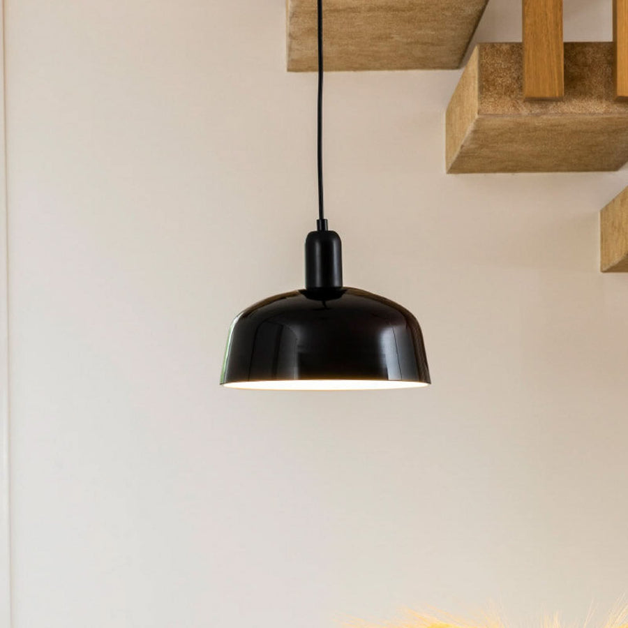 Suspension noire en verre, vue rapprochée sous une étagère en bois.