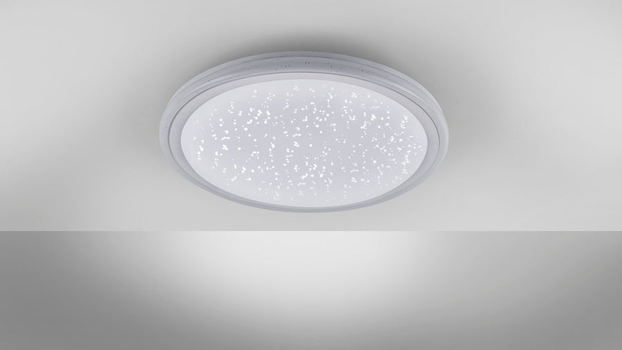Plafonnier blanc allumé au plafond diffusant une lumière étoilée