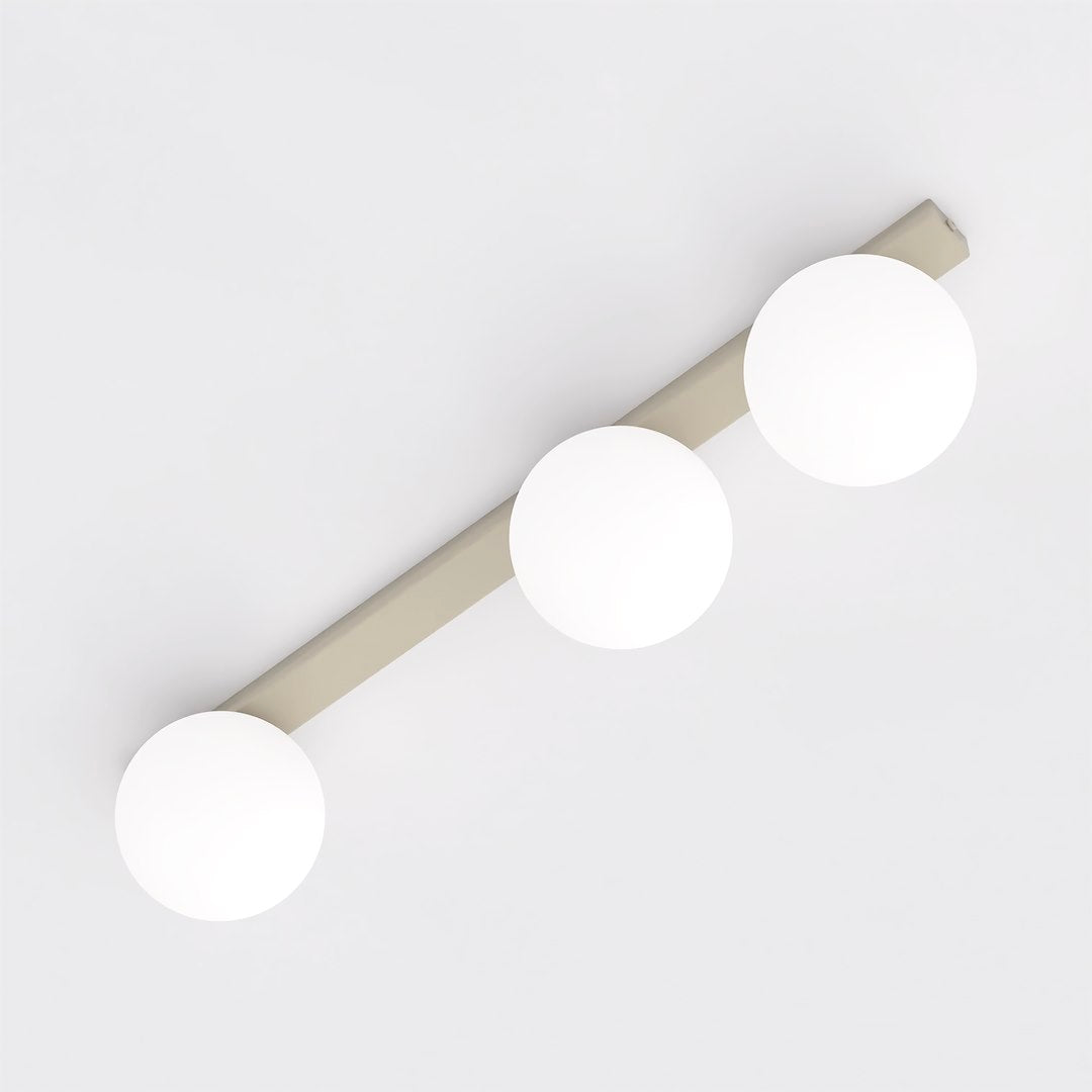 Vue en plongée montrant la barre beige et ses trois globes répartis.