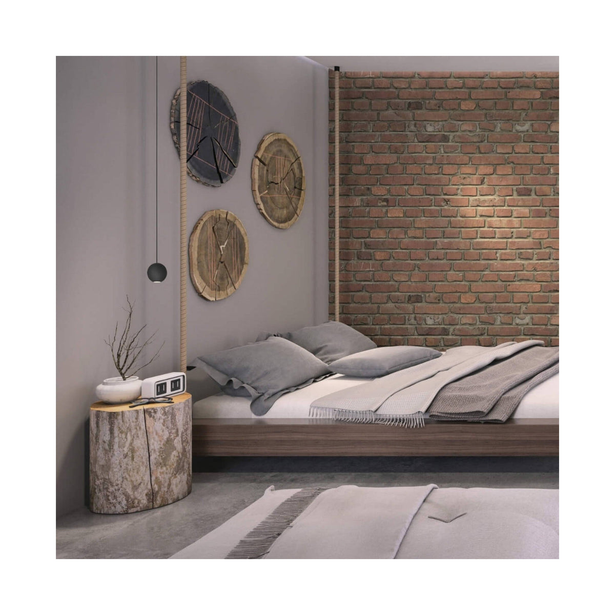 Vue large du décor : suspension noire et chevets en bois brut dans une chambre industrielle