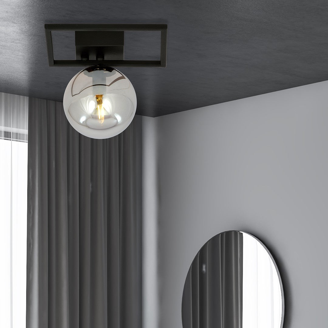 Mise en ambiance sous plafond sombre, rideaux gris et miroir rond dans une chambre