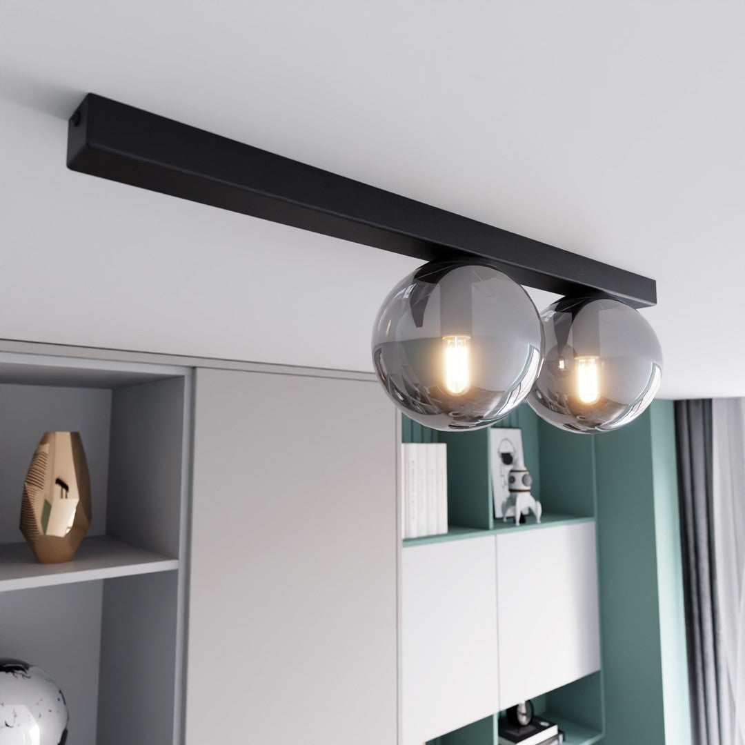 Plafonnier installé au plafond au-dessus d'une bibliothèque, éclairant une pièce au style contemporain.