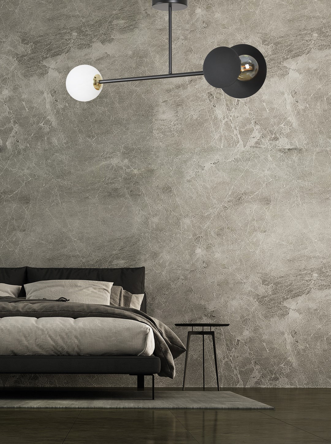 Mise en ambiance du plafonnier au-dessus d'un lit dans une chambre au mur béton.