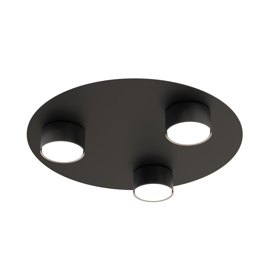 Vue de dessous du plafonnier rond noir et de ses trois cylindres lumineux.