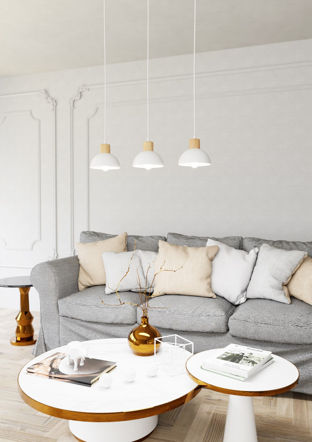 Mise en ambiance dans un salon, suspension au-dessus d'un canapé gris et d'une table basse.