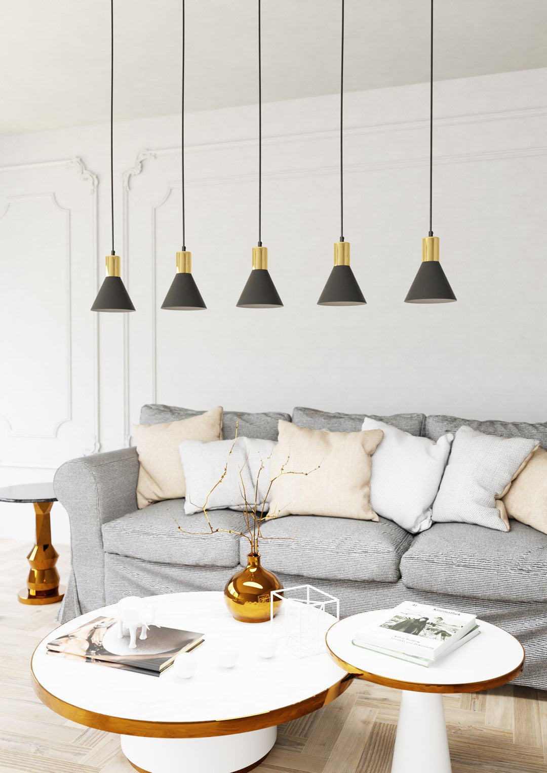 Luminaire installé au-dessus d'un canapé gris dans un salon blanc aux moulures