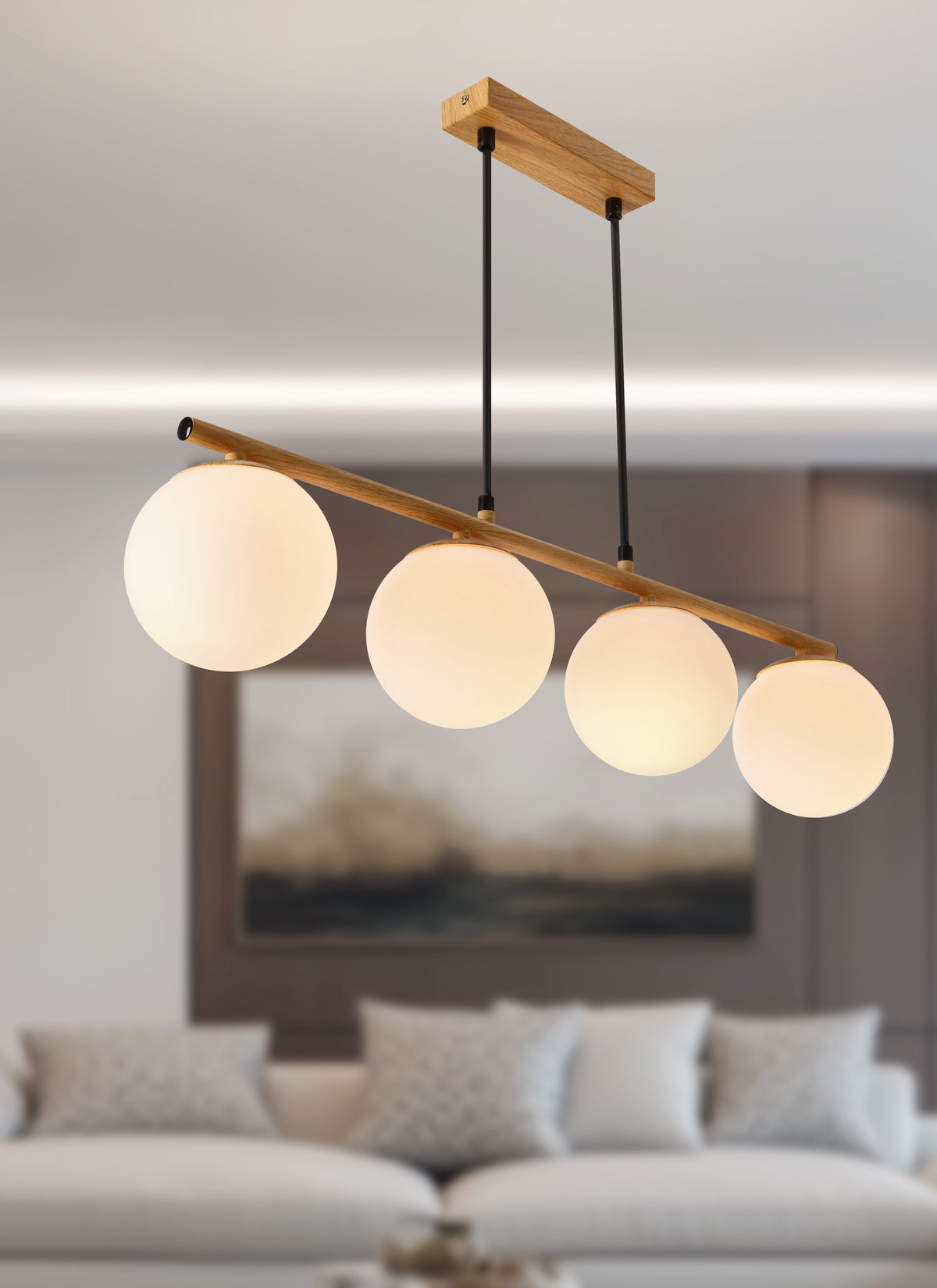 Quatre globes en verre blanc allumés, vus en perspective sous un plafond.