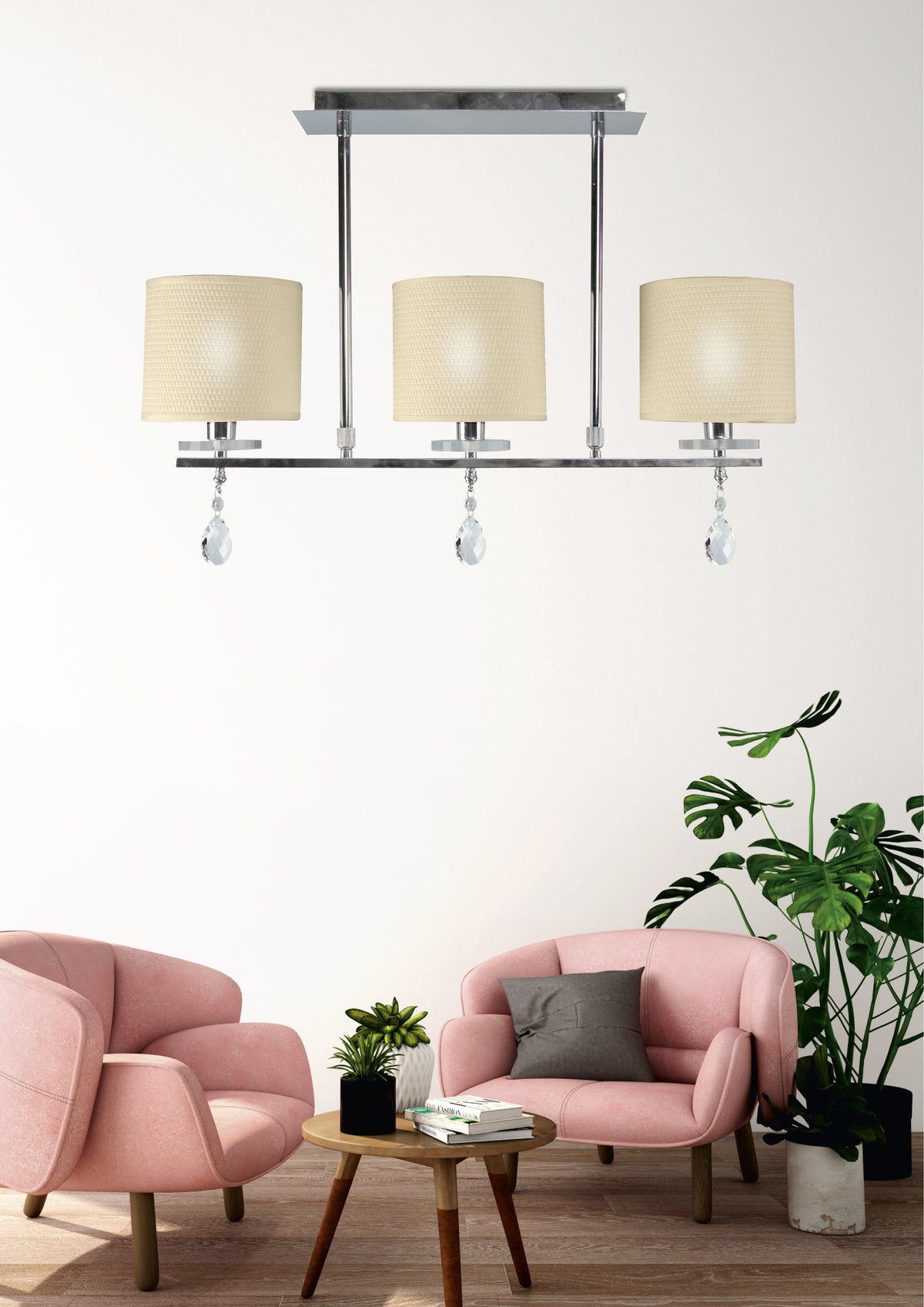 Vue en situation dans un salon, fauteuils roses et plante verte