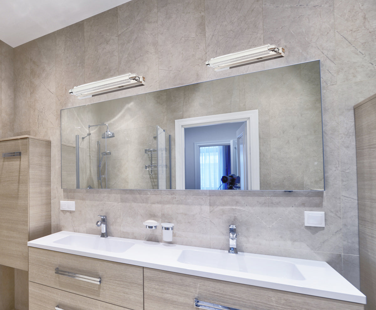 Mise en ambiance dans une salle de bain, deux appliques fixées au-dessus du miroir