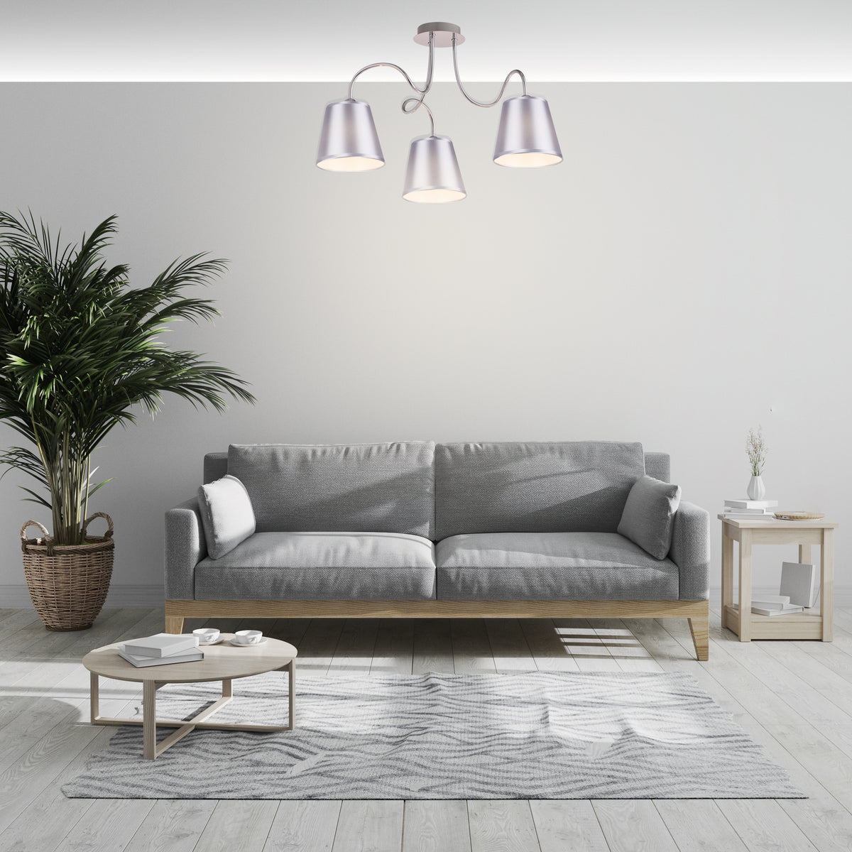 Mise en ambiance dans un salon contemporain, suspension installée au plafond au-dessus d'un canapé gris.