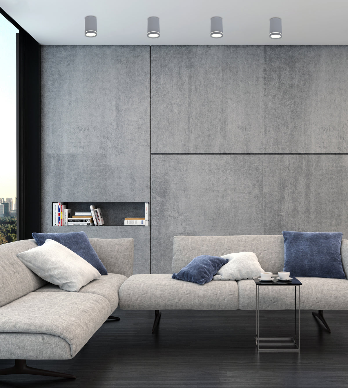 Mise en ambiance salon béton avec quatre luminaires cylindriques gris fixés au plafond