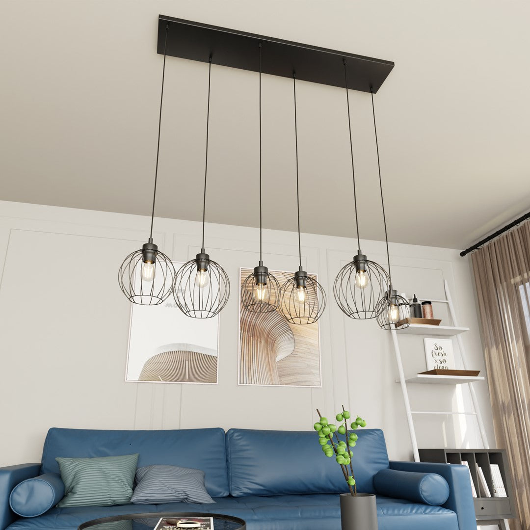 Suspension allumée au-dessus d'un canapé bleu dans un salon contemporain.