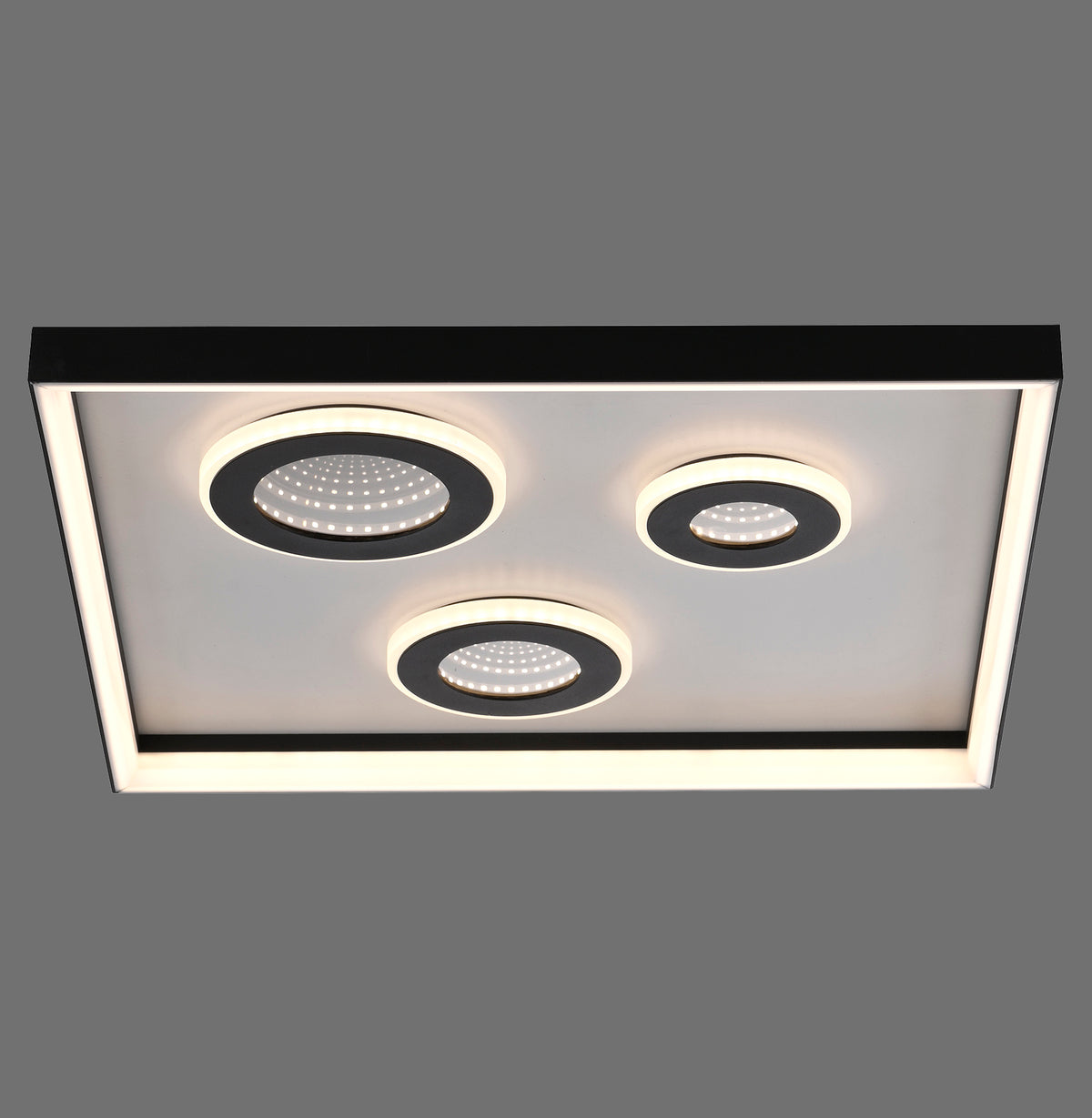 Plafonnier rectangulaire noir vu de face avec trois modules lumineux circulaires LED