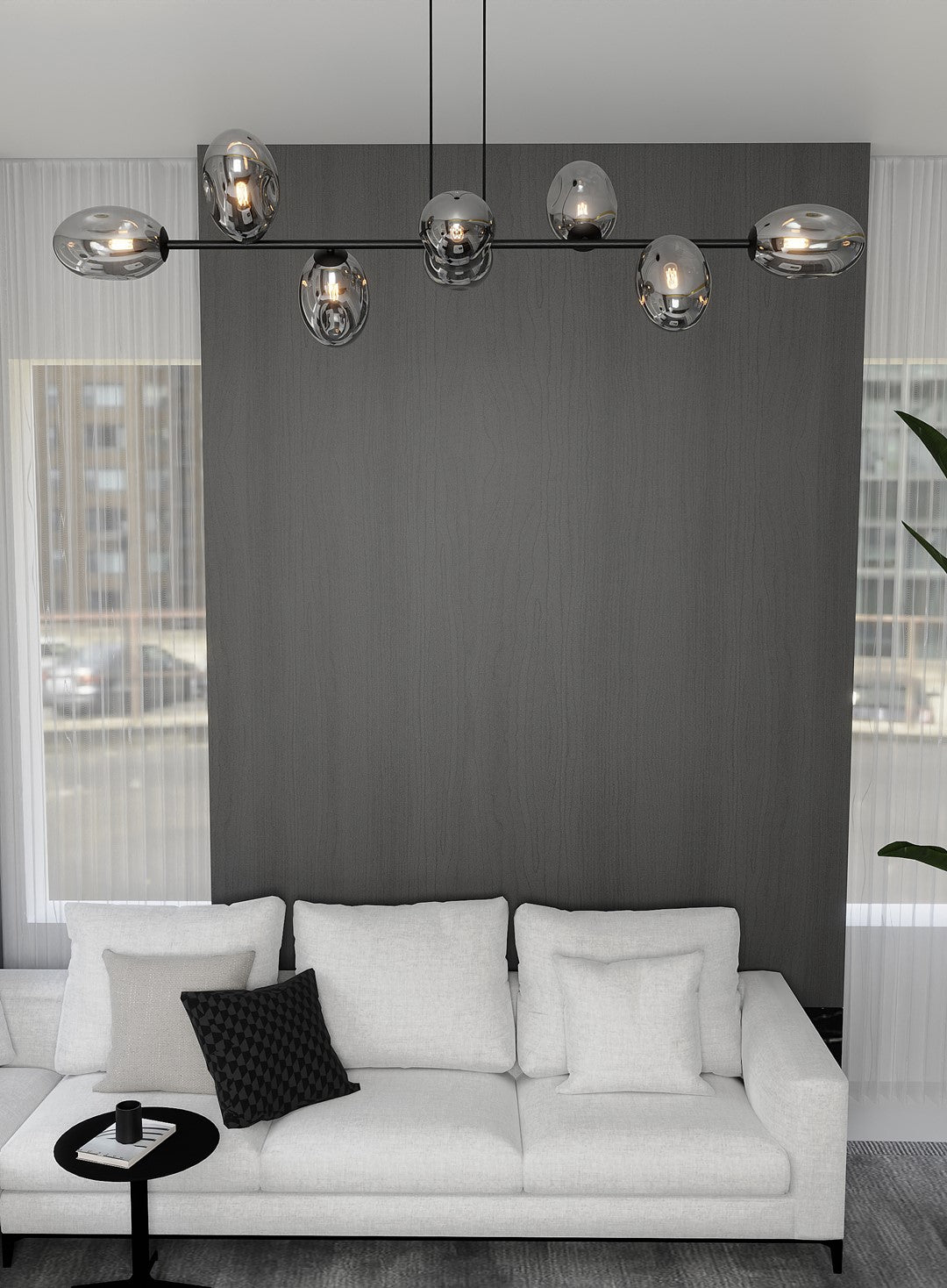 Luminaire suspendu au-dessus du canapé blanc, ampoules visibles dans le verre fumé
