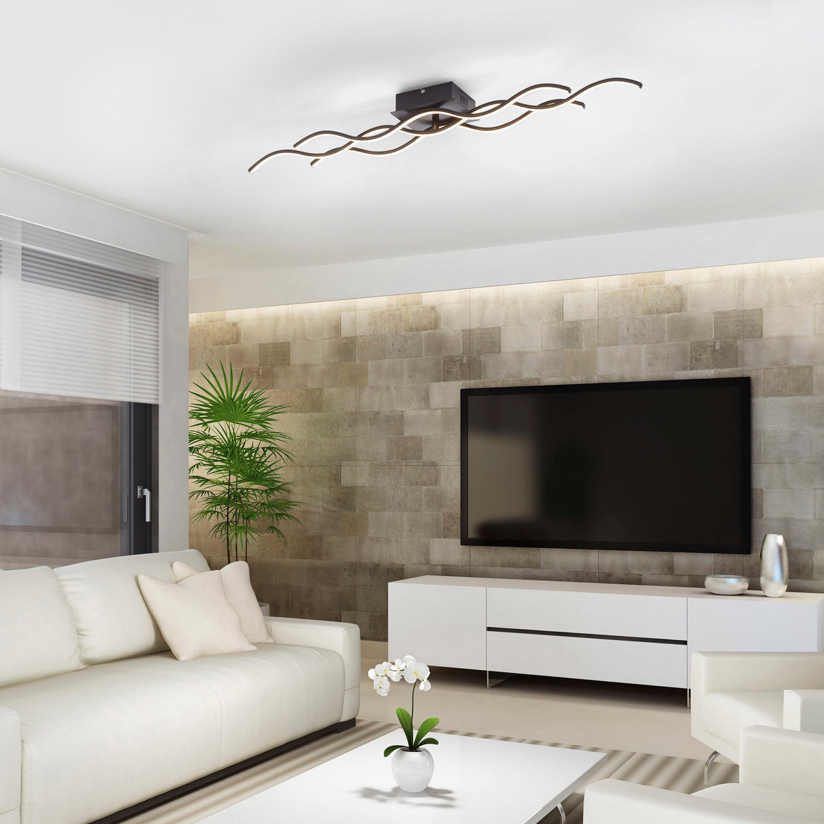 Mise en ambiance dans un salon contemporain, plafonnier installé au plafond au-dessus du canapé.