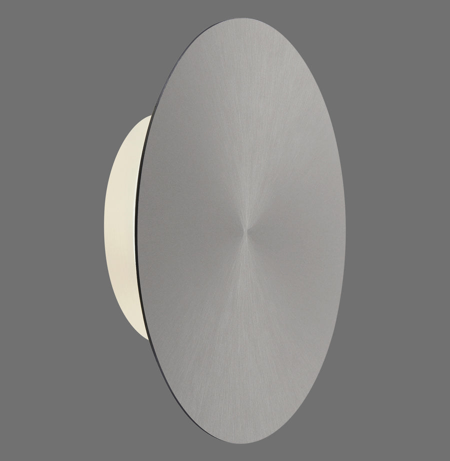 Vue de profil du disque gris brossé éclairé, halo lumineux diffus sur fond gris