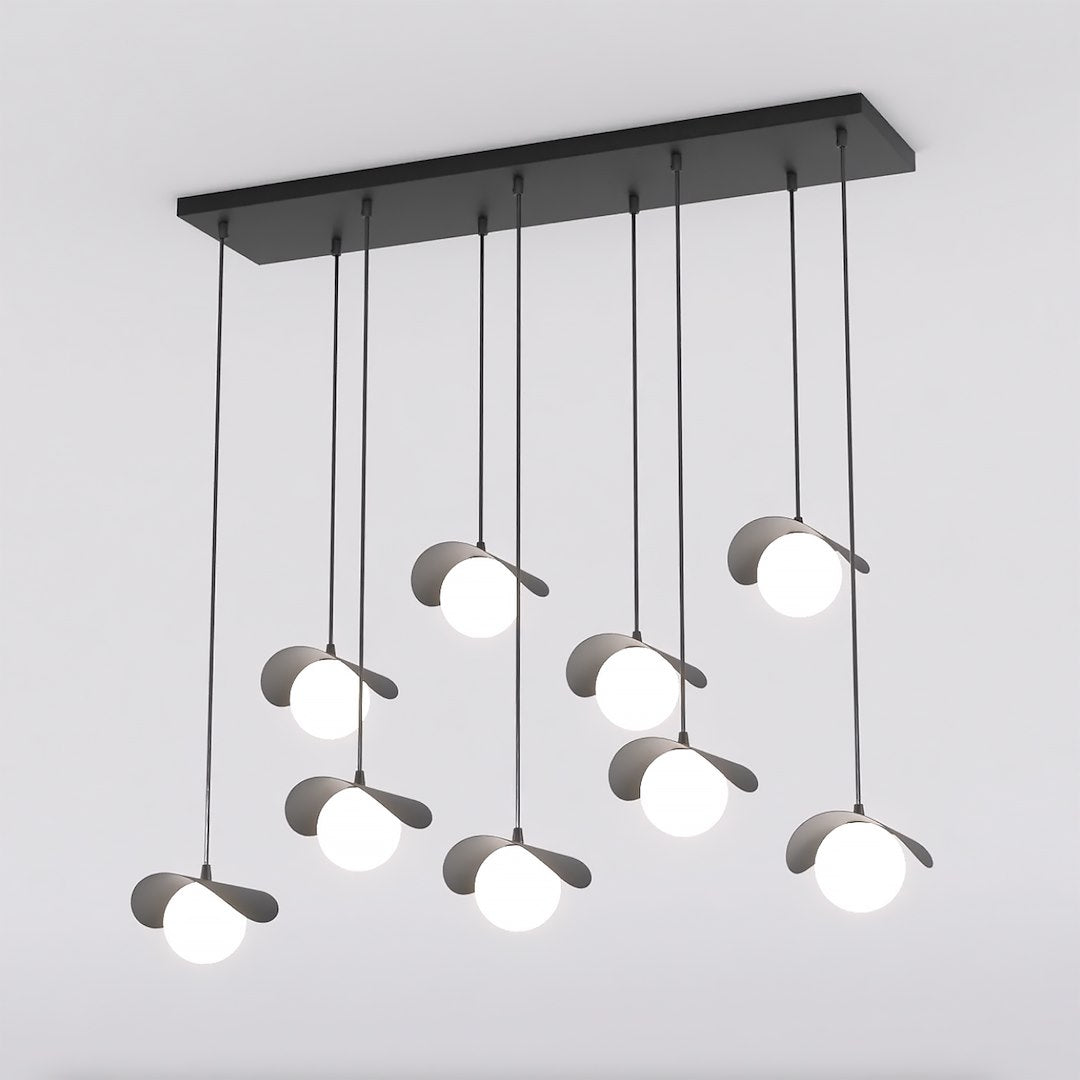 Vue de face de la suspension noire et de ses neuf globes opalins sur tiges