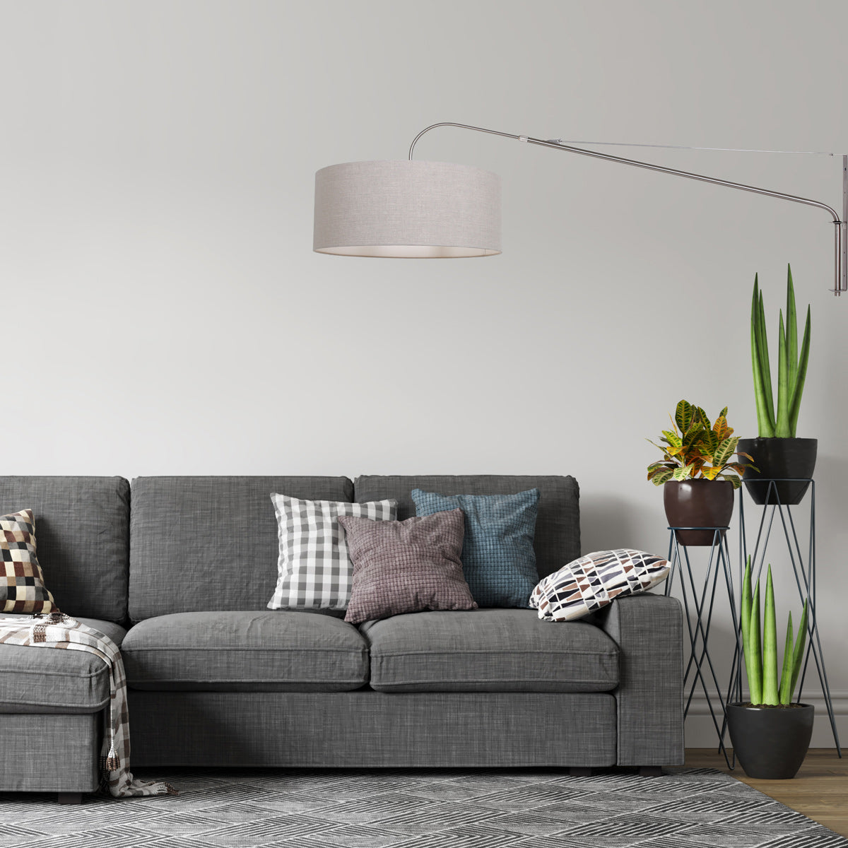 Mise en ambiance du luminaire mural au-dessus d'un canapé gris.
