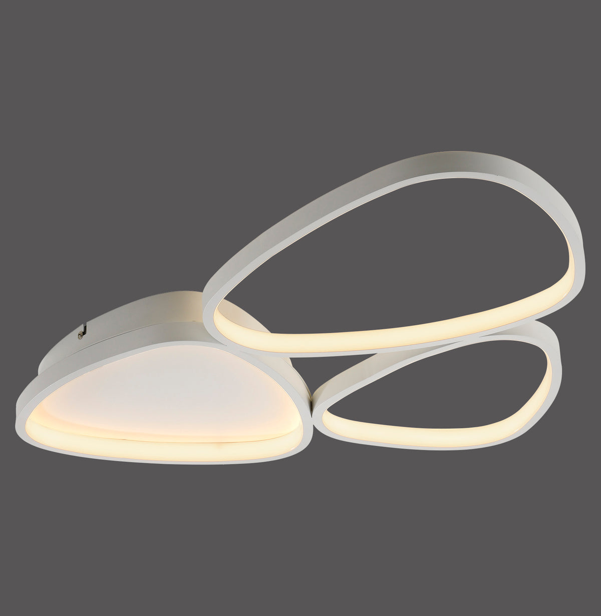 Luminaire blanc à trois formes de galets superposées, éclairé sur fond gris.