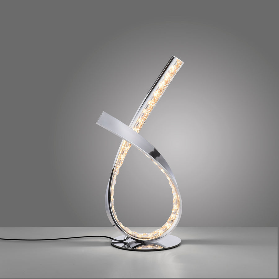 Luminaire allumé posé sur surface grise, câble d'alimentation visible