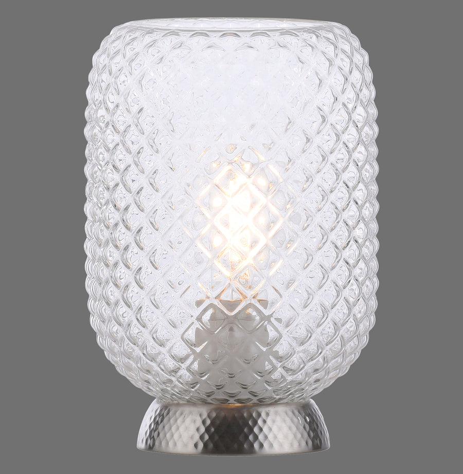 Lampe à poser en verre texturé, allumée, vue de face sur fond gris.