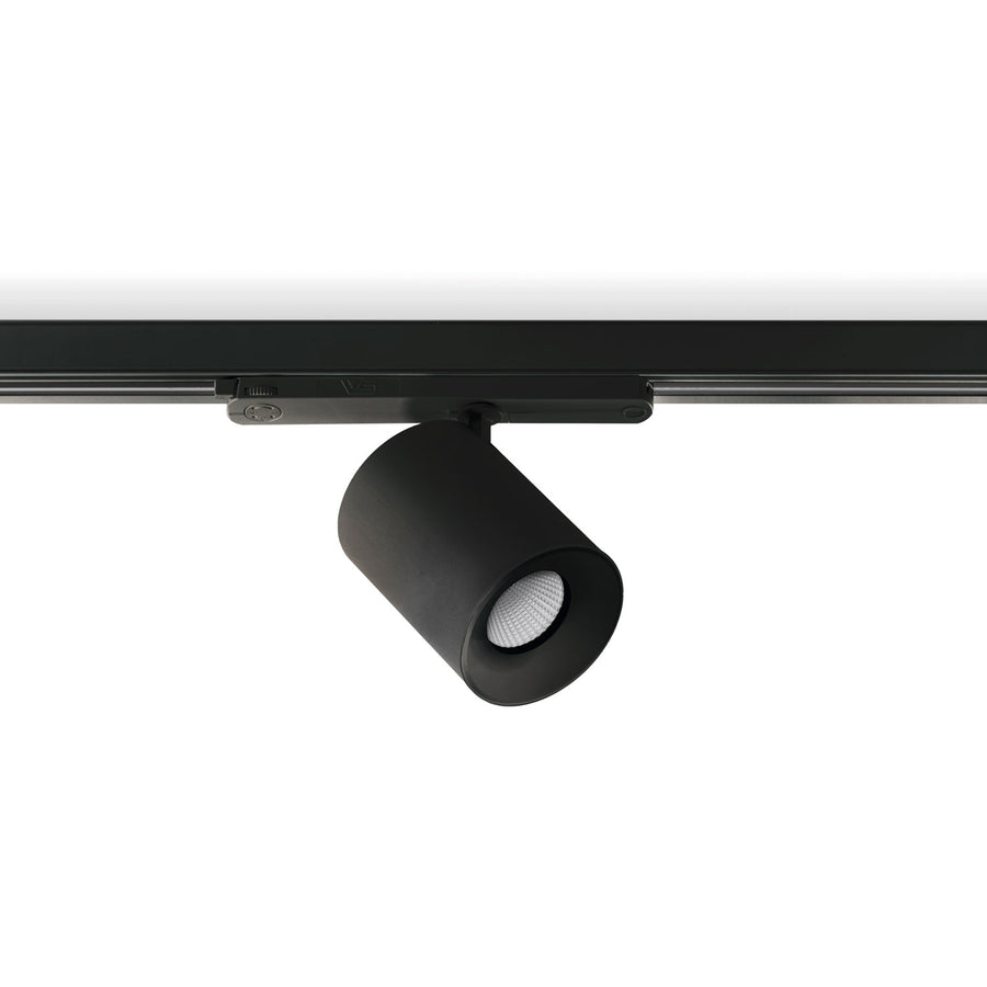 Spot noir sur rail, corps cylindrique mat et diffuseur LED strié en gros plan