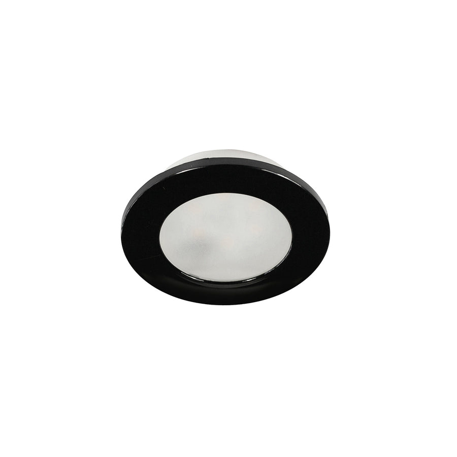 Spot encastrable noir vu de face, contraste entre collerette sombre et diffuseur.