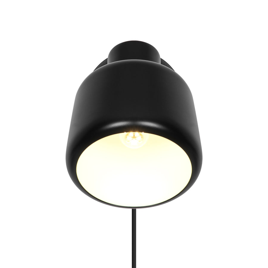 Vue de face du luminaire allumé montrant l'abat-jour arrondi