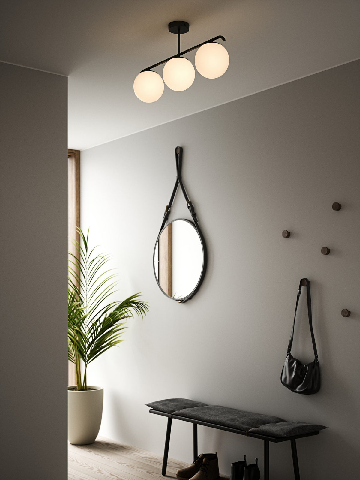 Ambiance entrée avec plafonnier noir allumé, miroir rond et banc