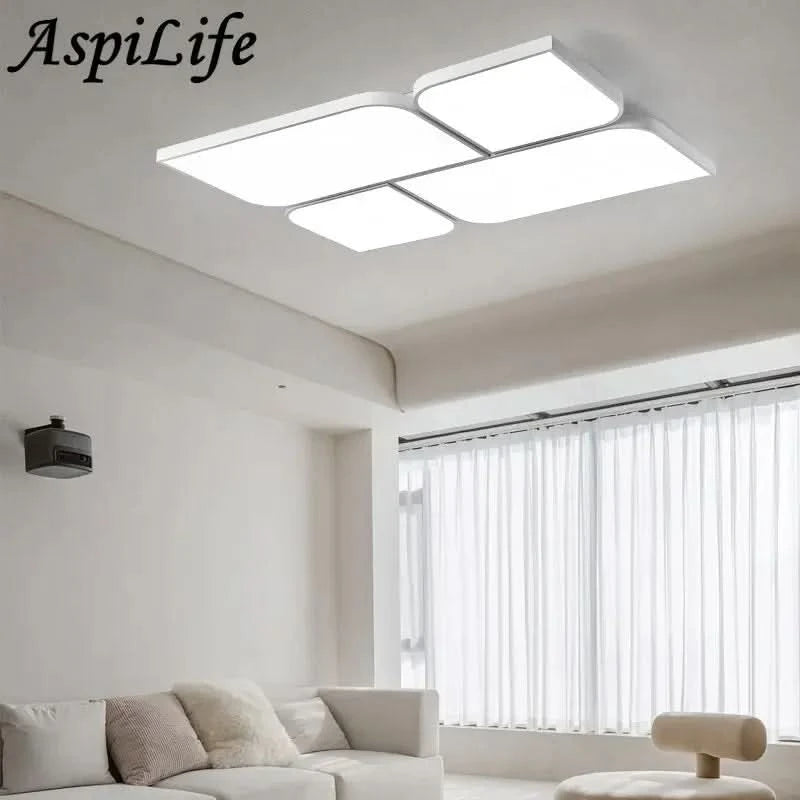 Vue de face du luminaire à quatre losanges blancs, installé au plafond d'un salon