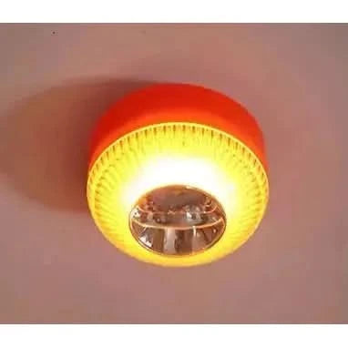 Lampe allumée fixée au plafond, lumière jaune orangé diffusée dans la pièce.