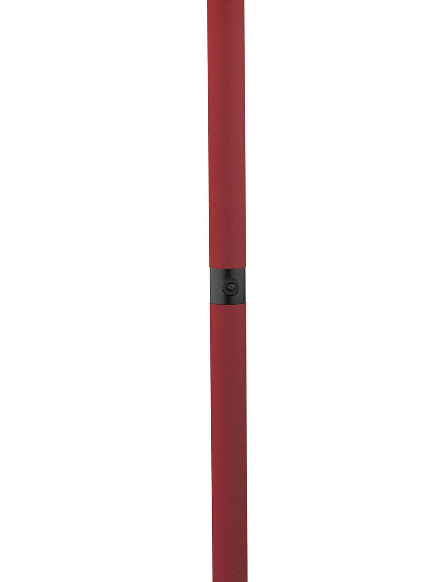 Détail du fût rouge, bague noire et bouton central, en gros plan vertical.