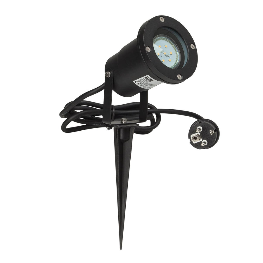 Projecteur noir avec câble enroulé et prise secteur, vue de trois quarts sur fond blanc.