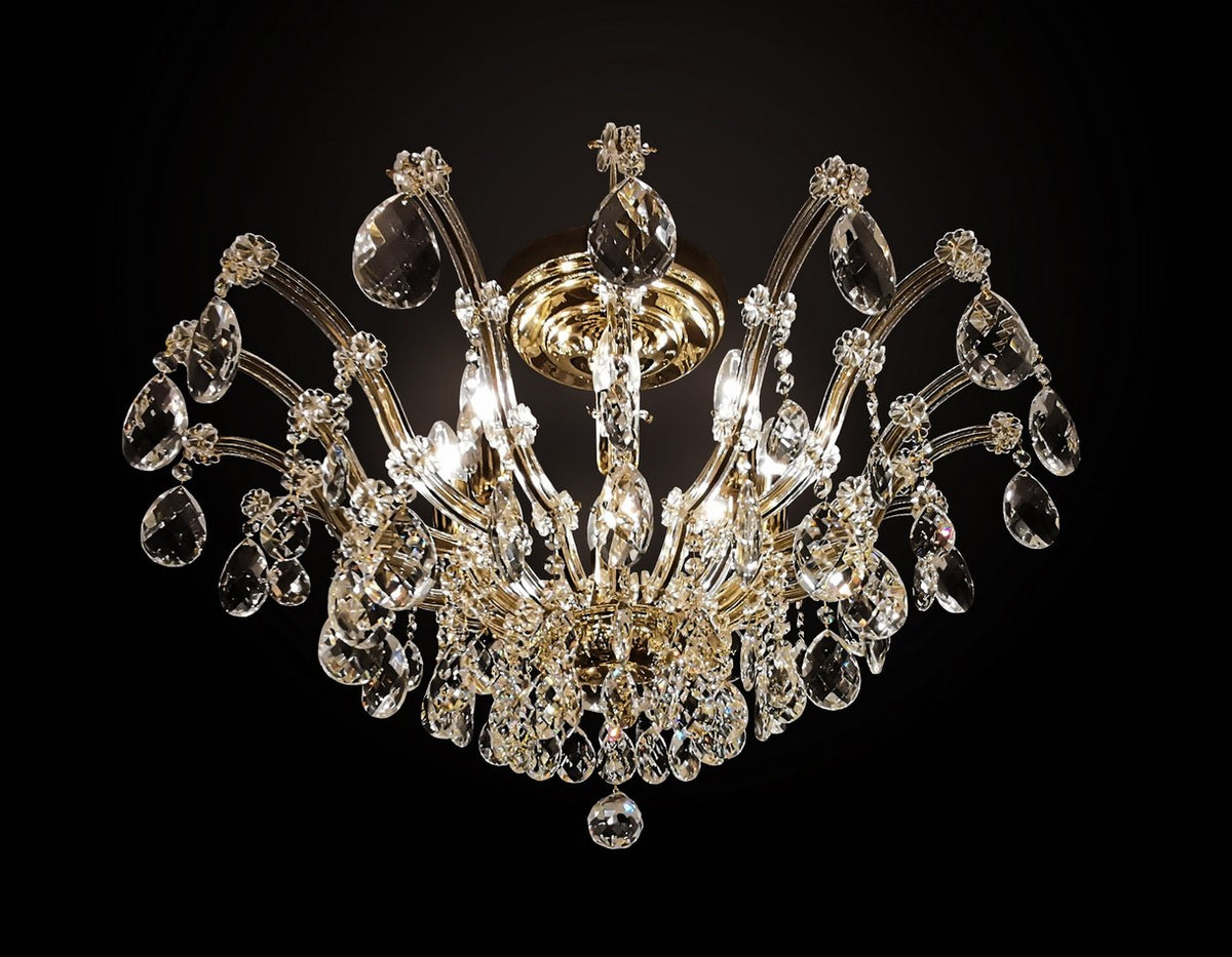 Lustre Marie-Thérèse en cristal, vue de face sur fond noir, bras dorés recourbés