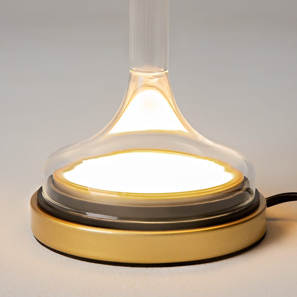 Détail du socle doré et de la base en verre éclairée par dessous