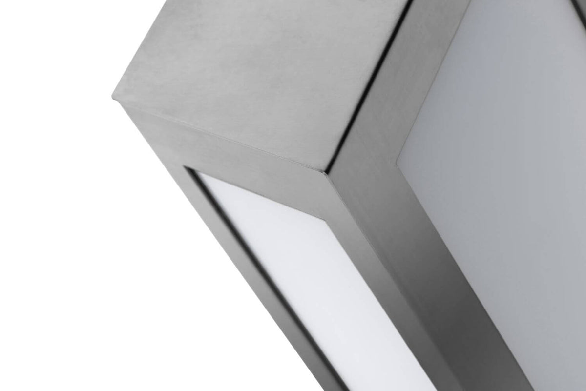 Vue rapprochée du cadre inox et du diffuseur, avec vis de fixation.