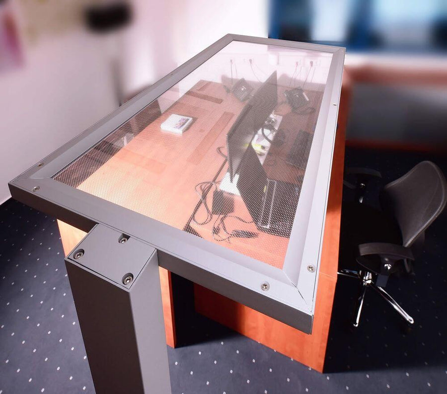 Détail de la tête en verre transparent et grille, posée au-dessus d'un bureau.