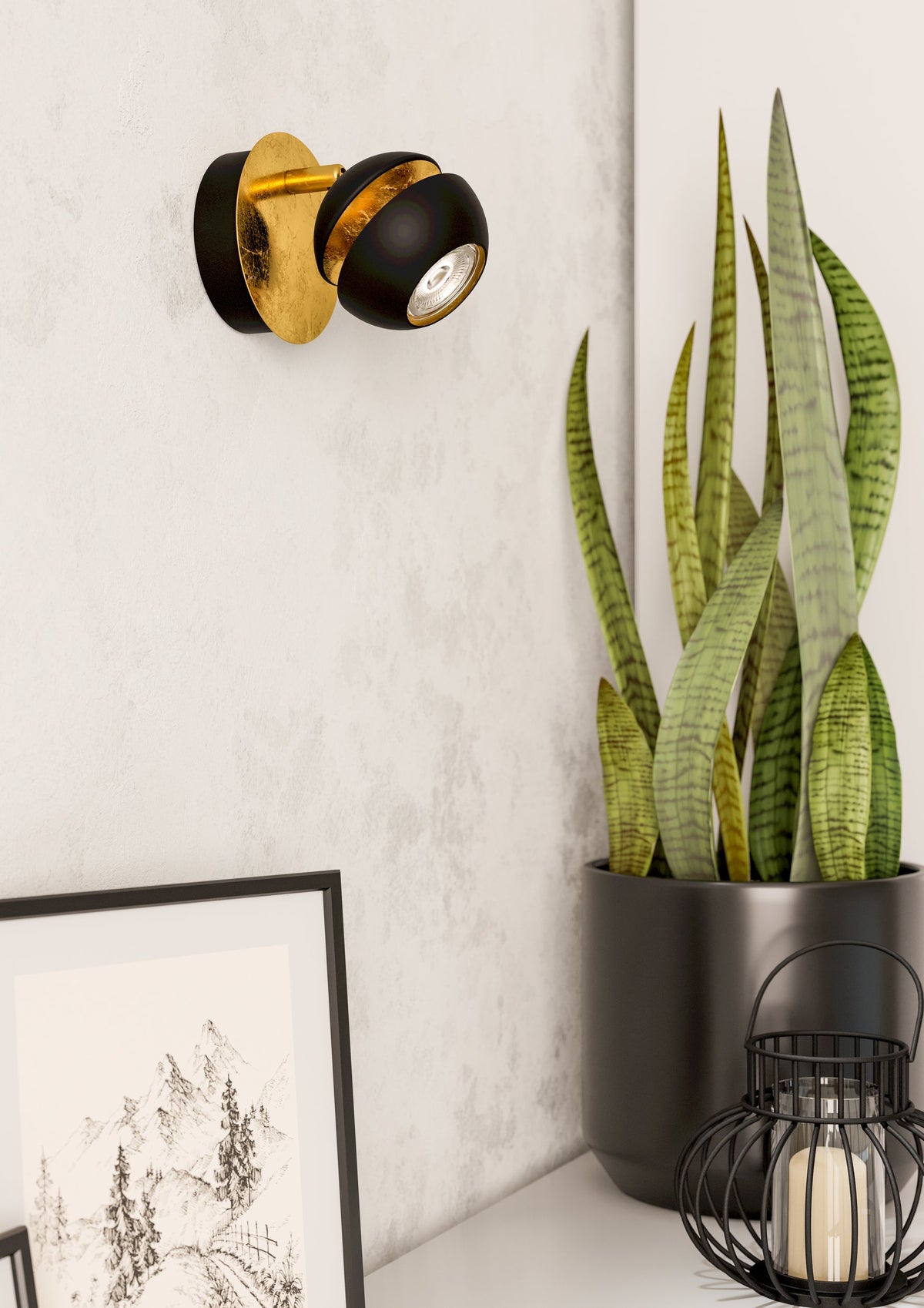 Mise en ambiance murale avec plante verte et cadre photo sous le spot
