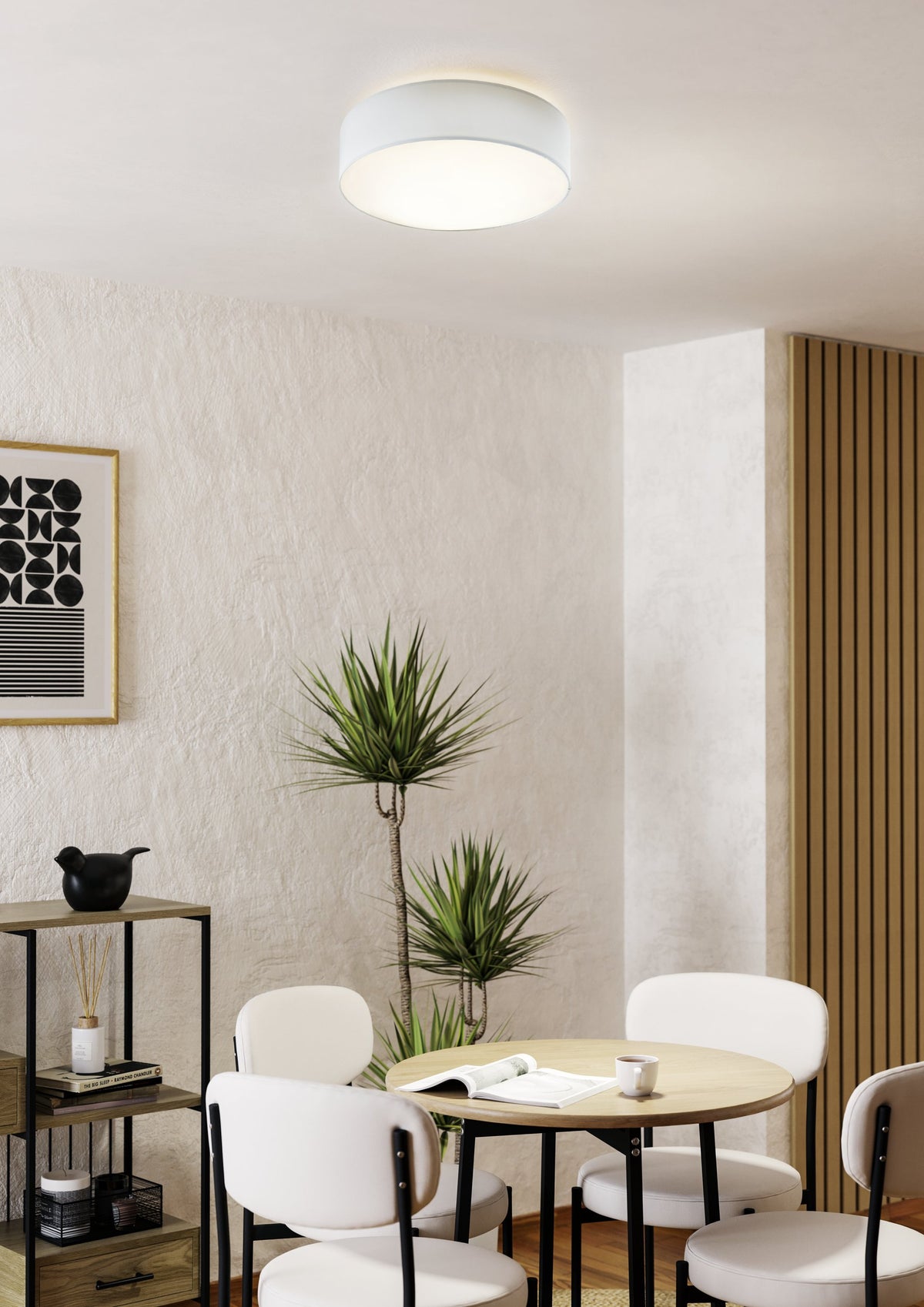 Mise en ambiance d'un plafonnier blanc au-dessus d'une table ronde dans un intérieur moderne.