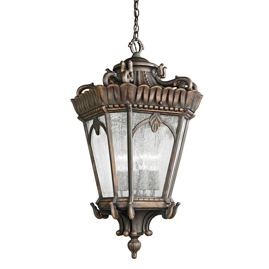 Lanterne suspendue vue de trois quarts, verre dépoli et armature ouvragée en bronze vieilli.