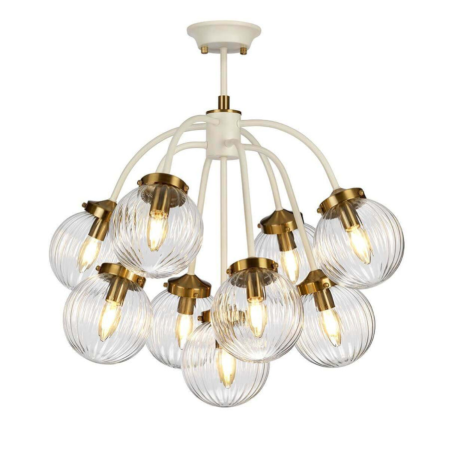 Luminaire présenté de face, grappe de globes verre cannelé et douilles en laiton