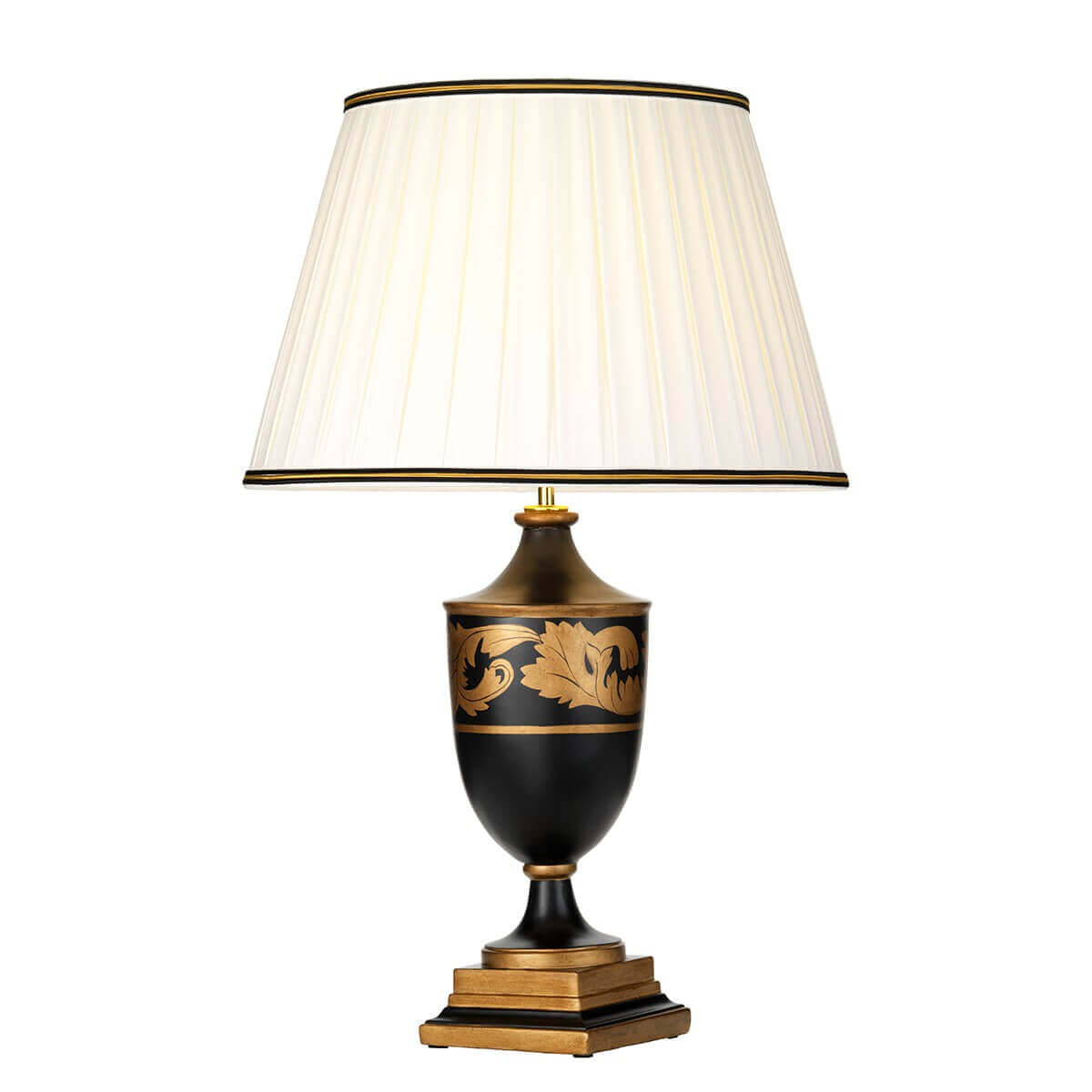Lampe à poser de face, socle pyramidal doré et corps noir orné de feuilles