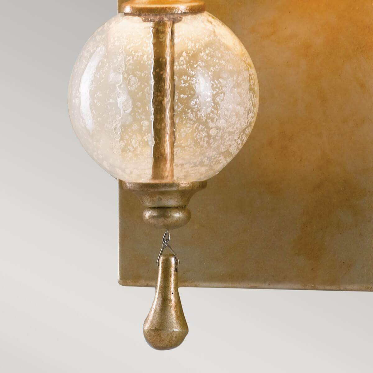Zoom sur la goutte métallique suspendue sous la sphère de verre dépoli
