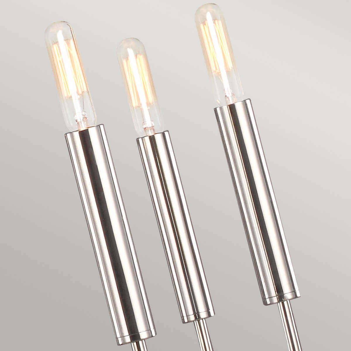 Détail des douilles cylindriques et des ampoules allumées émettant une lumière chaude