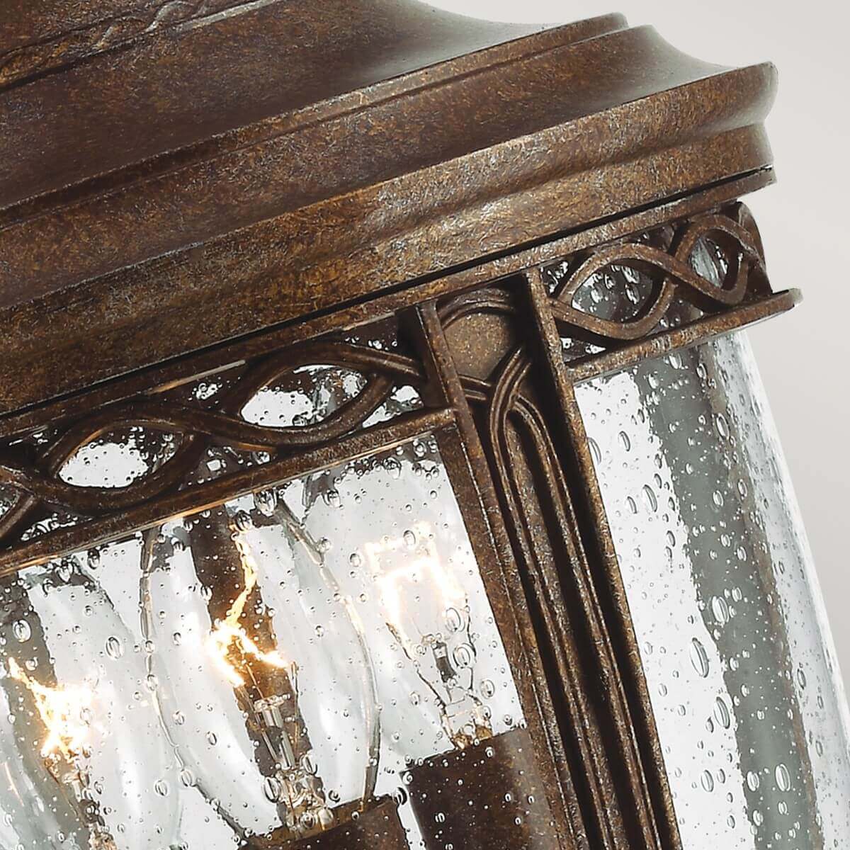 Détail de la bordure ajourée et du verre tacheté par la pluie, cadre métallique ouvragé.